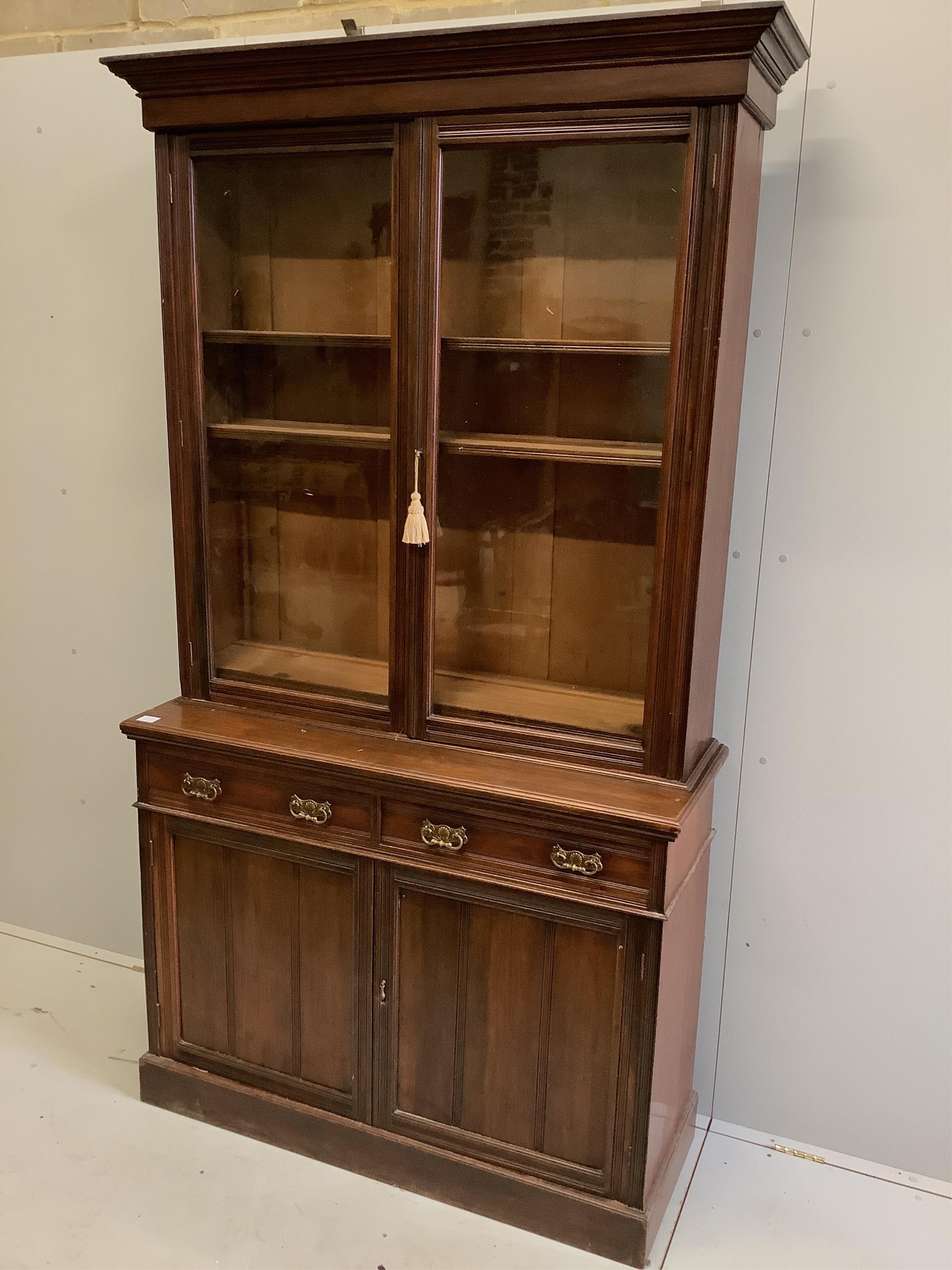 A late Victorian mahogany bookcase cabinet, width 122cm, depth 43cm, height 225cm. Condition - fair